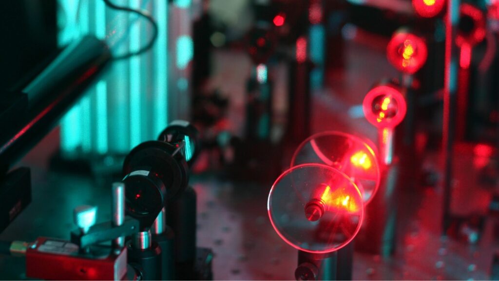 red lasers through filters close up of laser lab breadboard